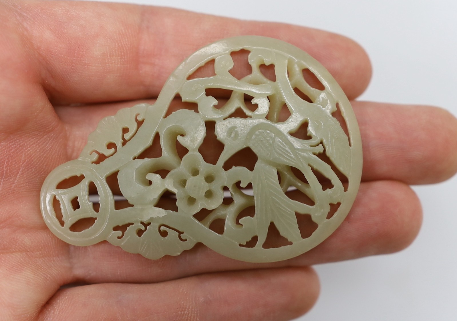 A Chinese celadon jade reticulated pendant. 7cm tall